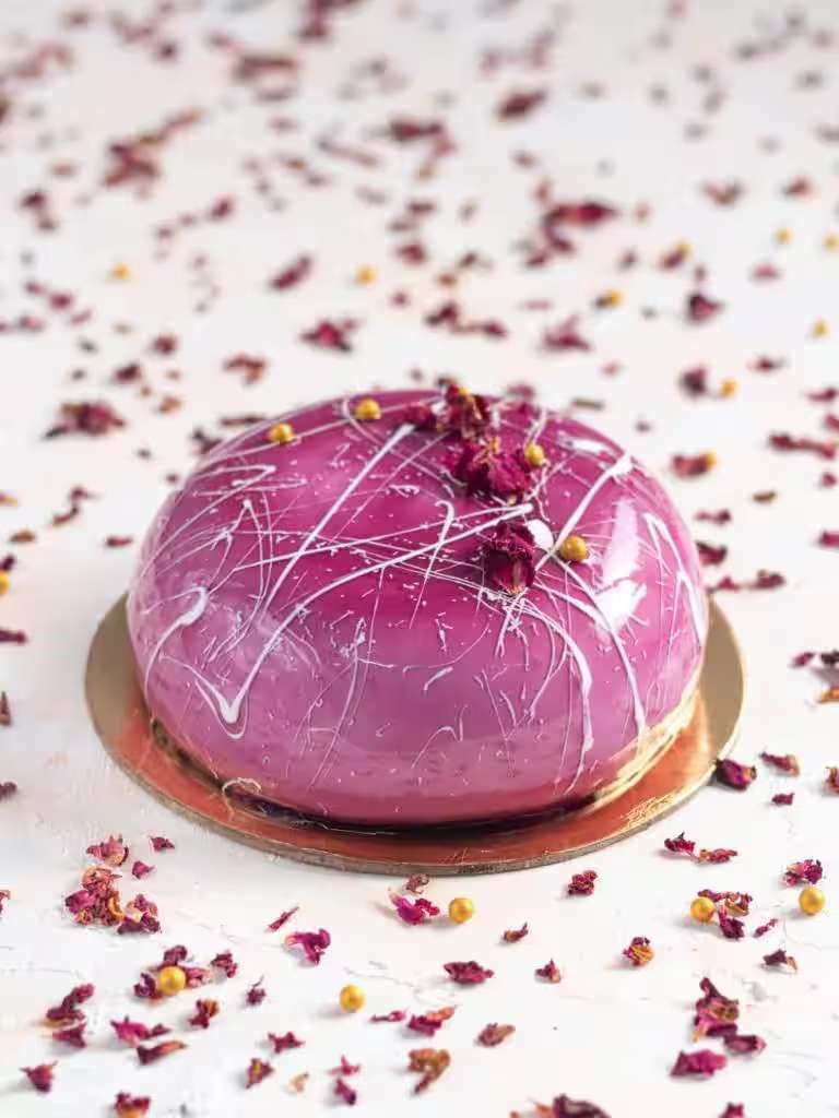 Glazed berry entremet finished with dried petals